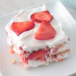 Slice of strawberry icebox cake on white plate