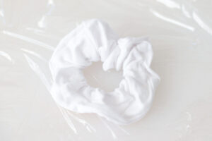 white knit scrunchie on plastic wrap