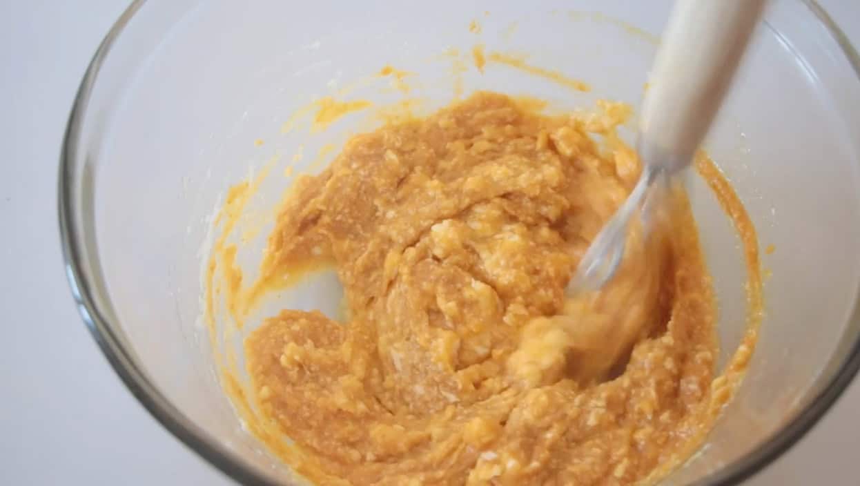 Mixing bowl with pumpkin batter and danish dough whisk.