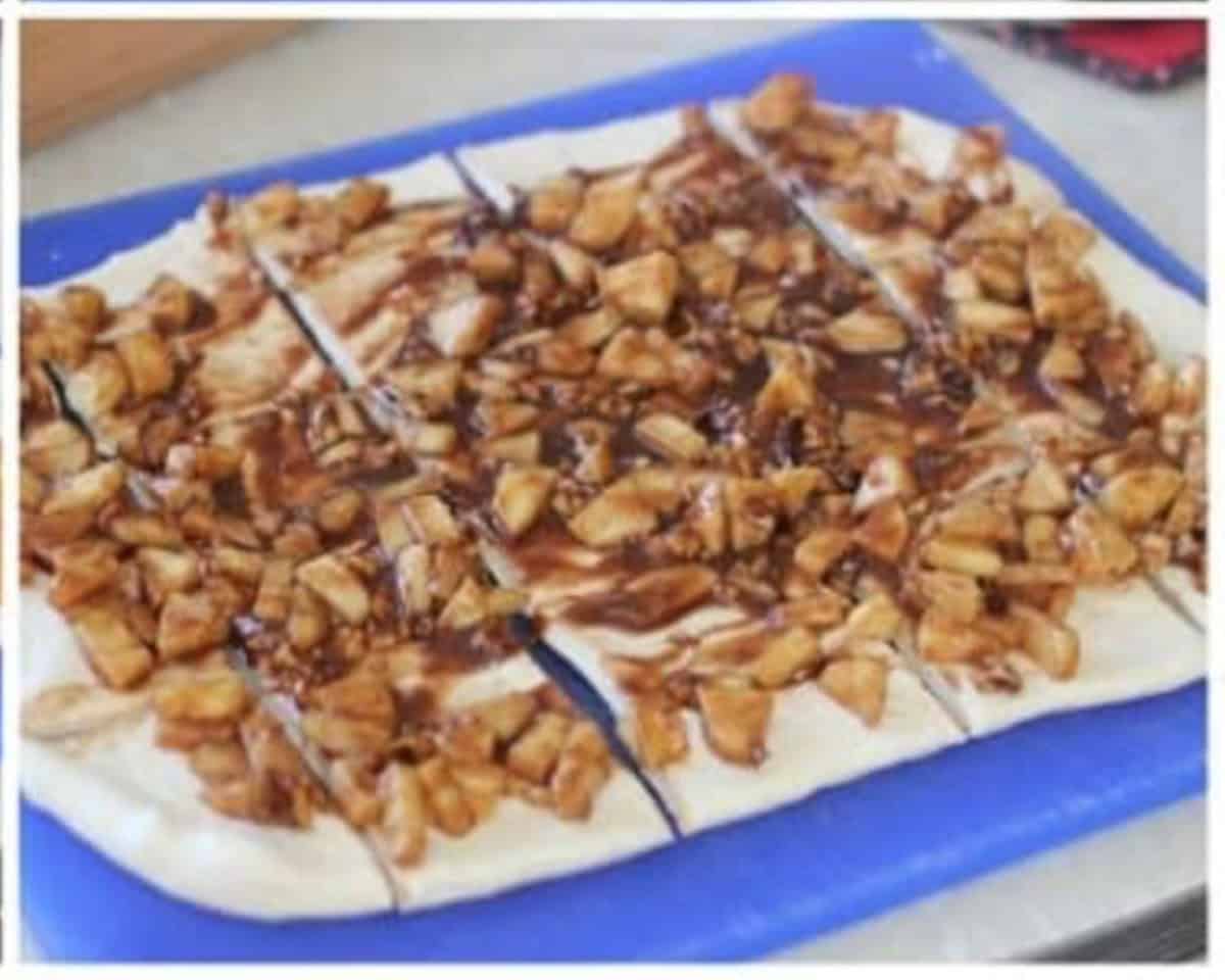 Apple filling spread over rolled out bread dough and cut into squares.