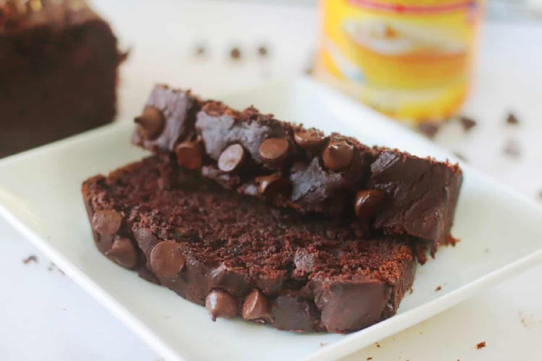 Two slices of chocolate pumpkin bread on white plate.