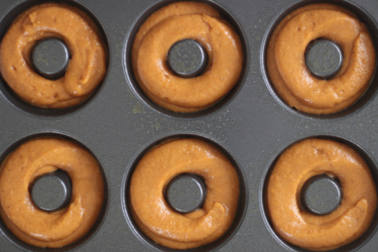 unbaked donut batter in donut pan