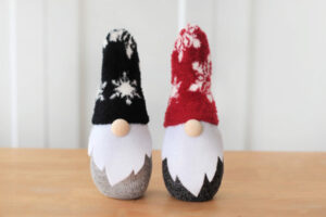 red and black sock gnome on table