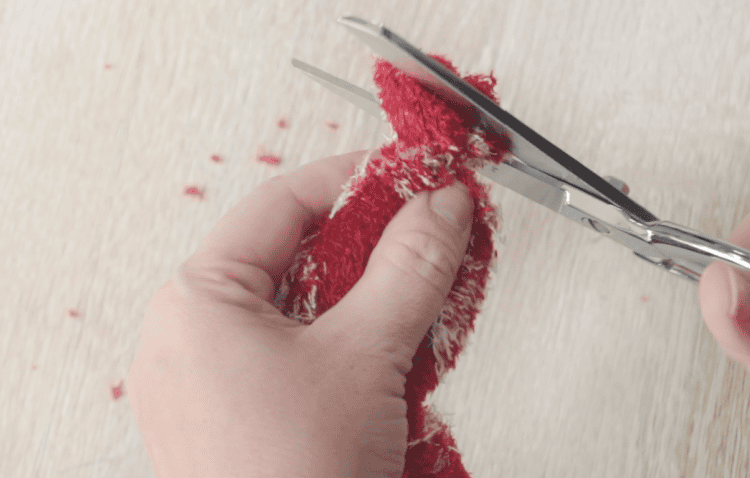 Scissors trimming sock hat.