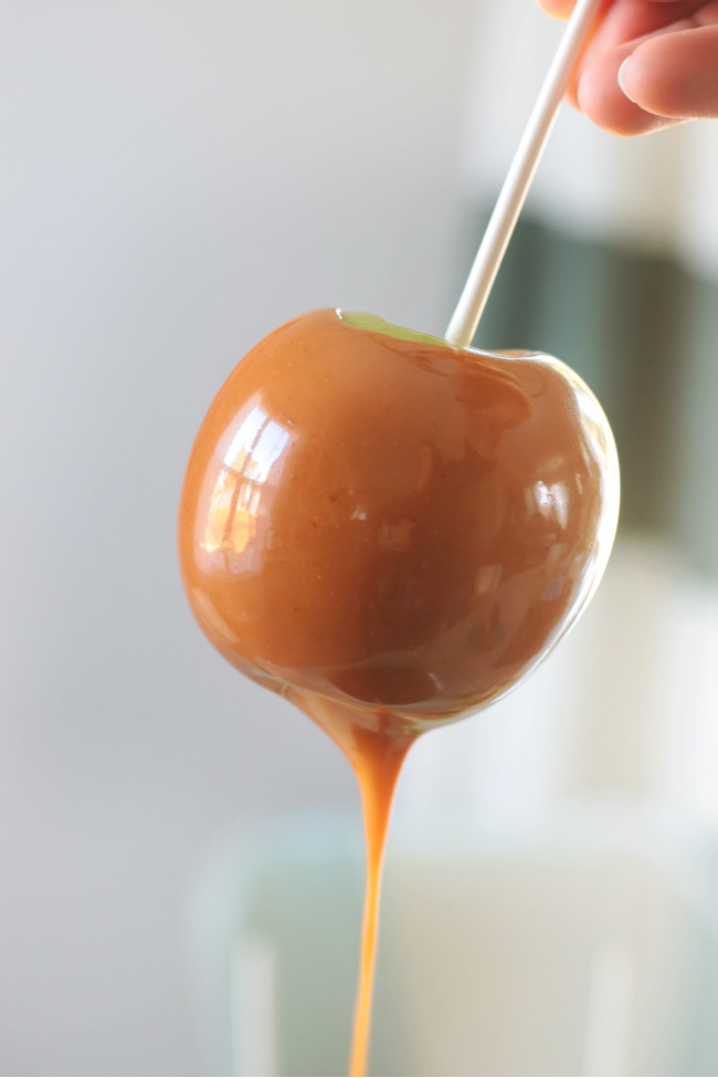 caramel dripping off fresh dipped apple