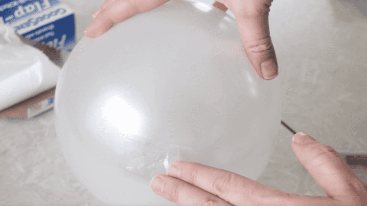 White balloon with tape on the end.