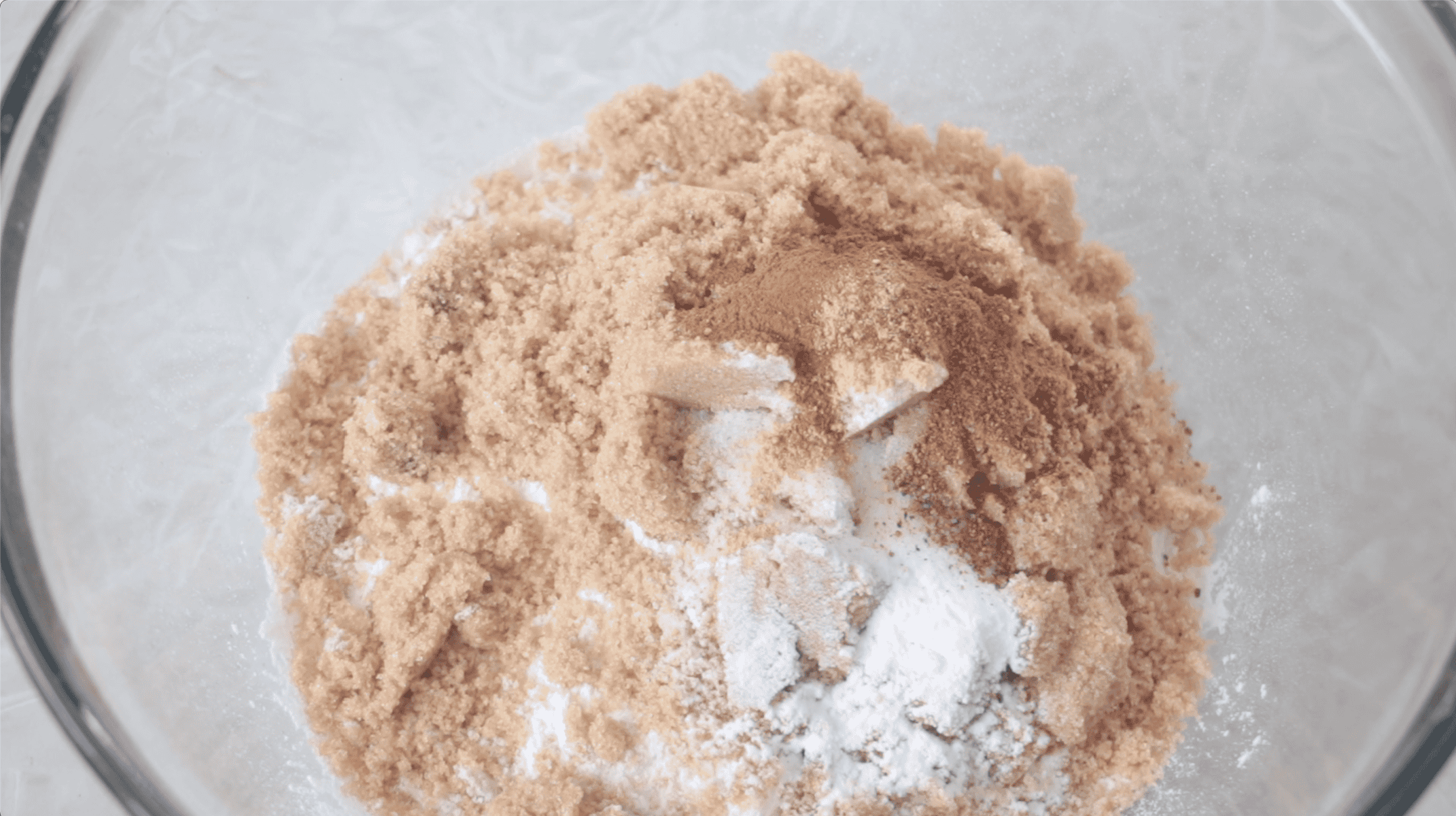 Mixing bowl with flour, cinnamon, nutmeg, cloves, baking soda, salt and brown sugar.
