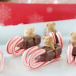 Candy sleds on a white platter.