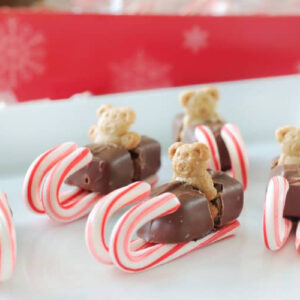 Candy sleds on a white platter.