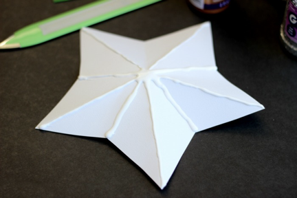 white paper star folded with glue on creases