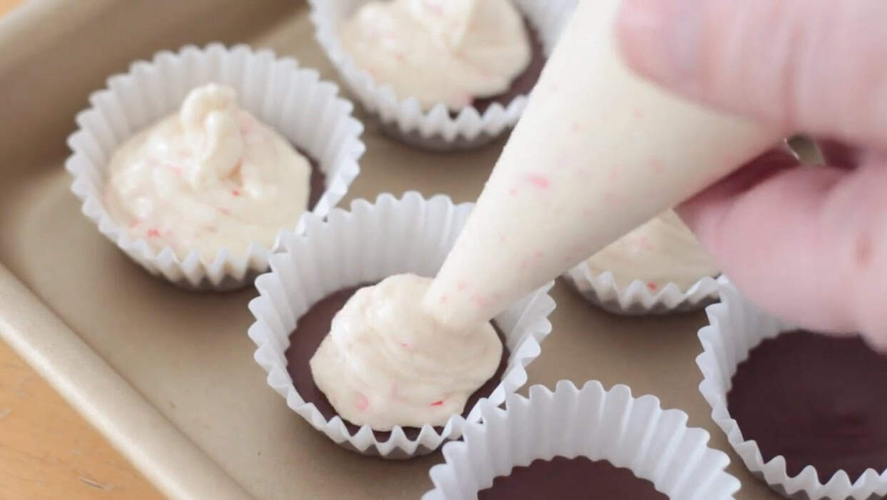 White chocolate piped on top of chocolate layer.