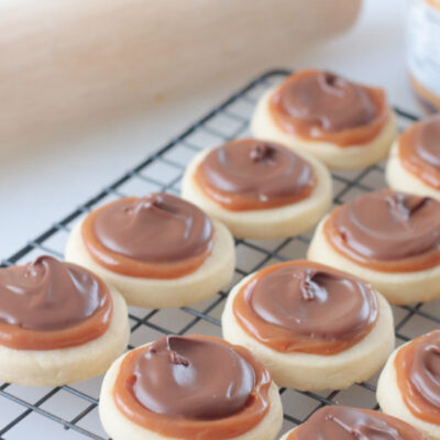 cookies with caramel and chocolate on cooling rack