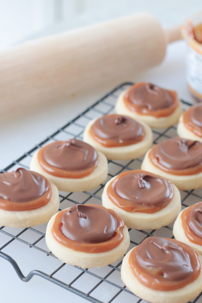 cookies with caramel and chocolate on cooling rack