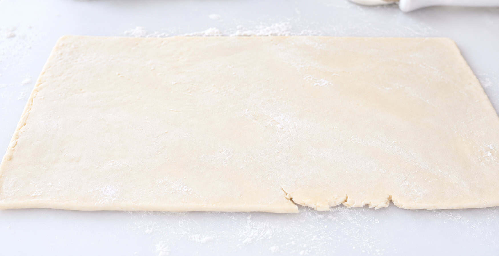 Puff pastry dough rolled into a rectangle.