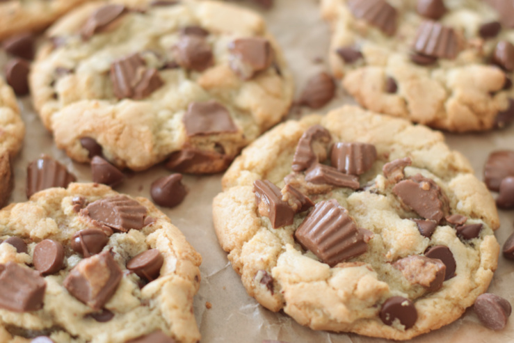 baked peanut butter cup cookies on parchment paper
