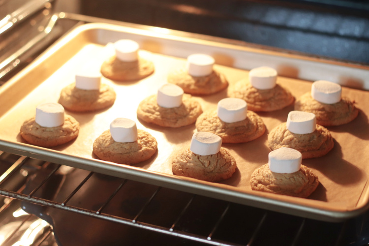 marshmallows on top of cookies in oven