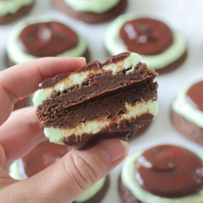 hand holding chocolate mint cookie cut in half