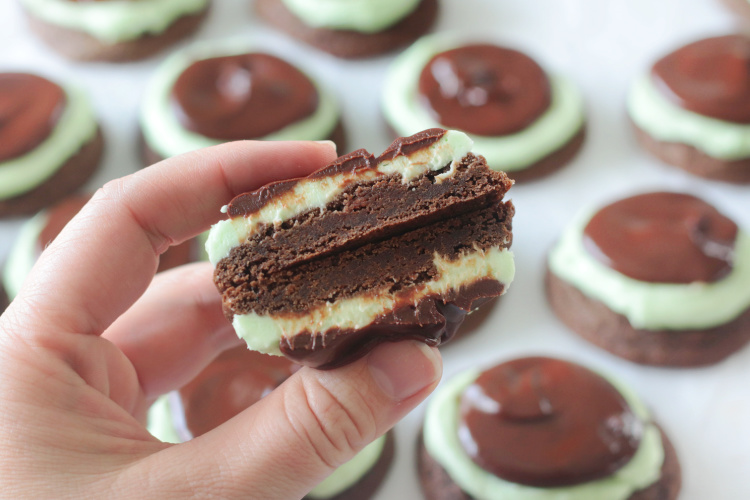 hand holding chocolate mint cookie cut in half