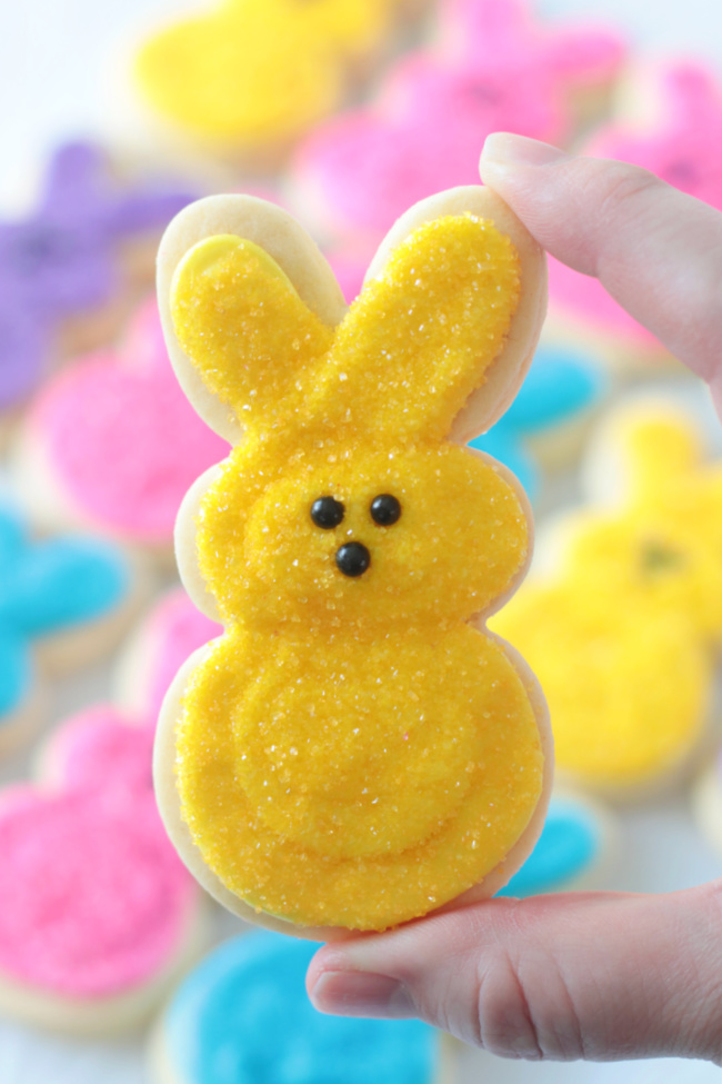 A vibrant array of Easter cookies decorated with icing, including bunny cookies, Easter egg cookies, and Easter basket cookies.