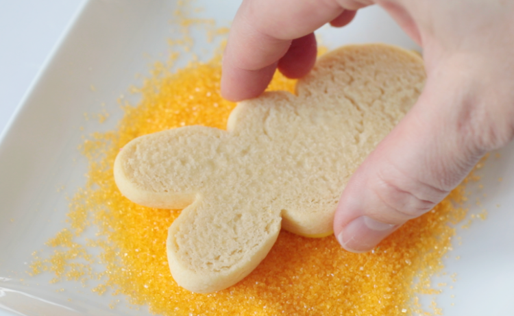 sugar cookie pressed into yellow sanding sugar