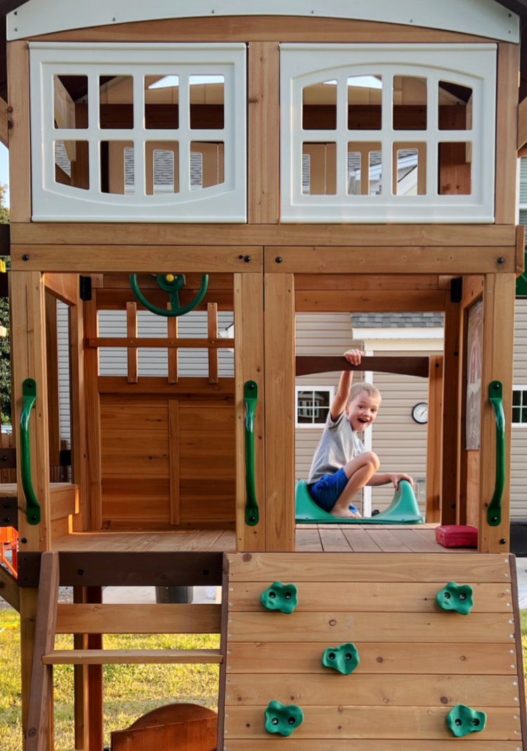 child climbing up a slide