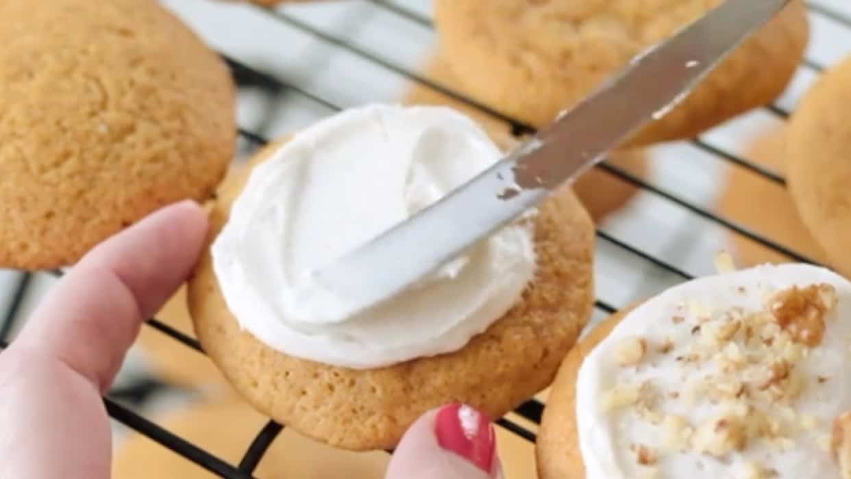 Carrot cookie with buttercream frosting spread on top.