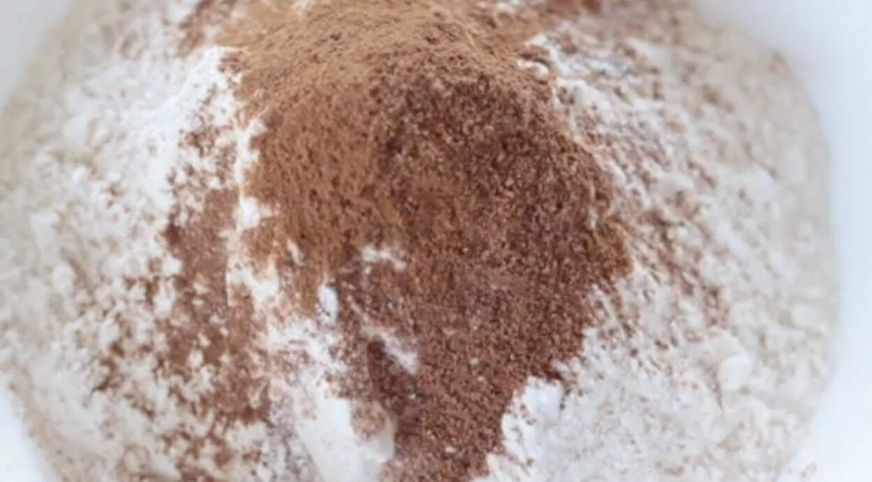 Mixing bowl with flour, baking soda, baking powder, salt, cinnamon and nutmeg.