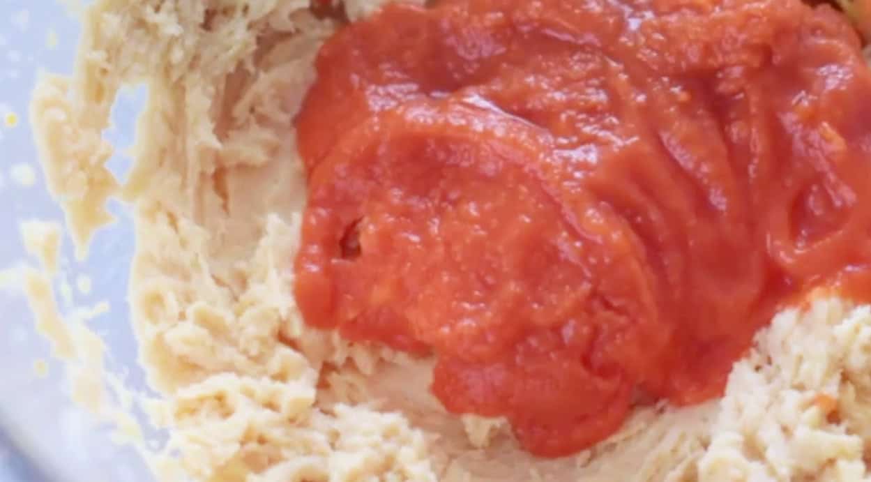 Carrot baby food poured over wet cookie ingredients.