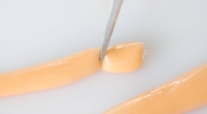 orange salt water taffy sliced using scissors