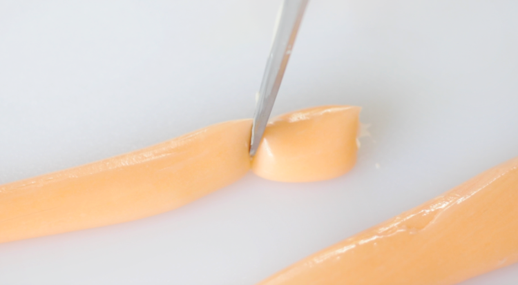 orange salt water taffy sliced using scissors