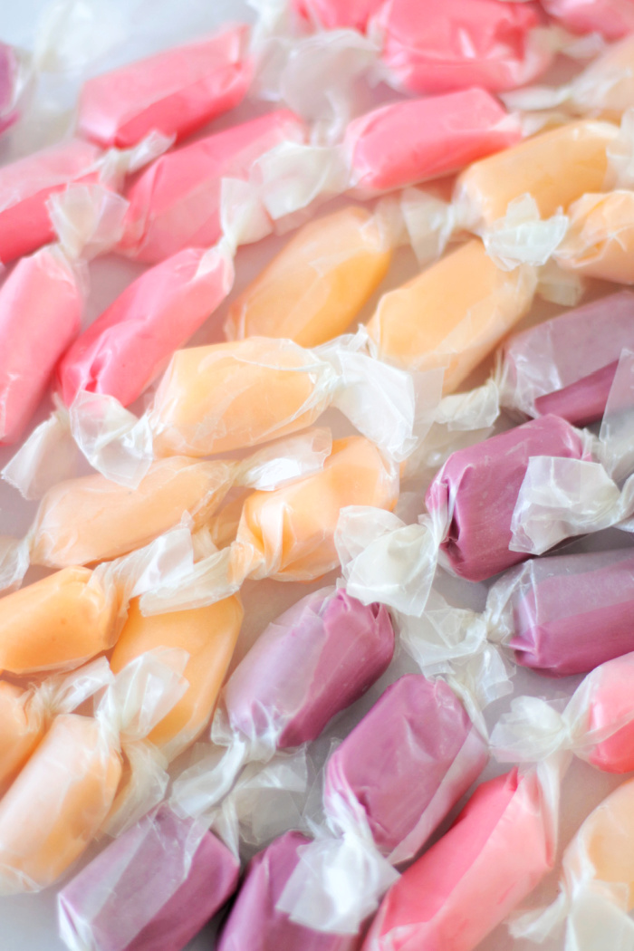 pink, purple and orange salt water taffy wrapped in wax paper