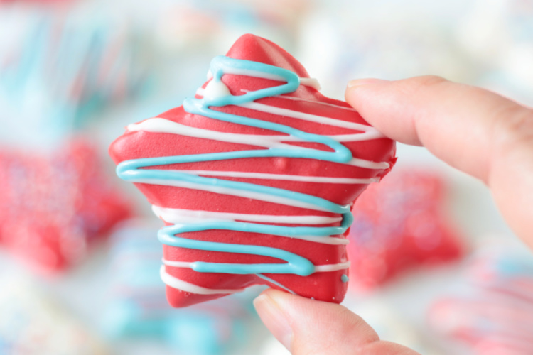 hand holding red patriotic cookie