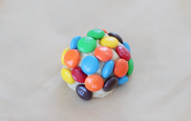ball of cookie douhg covered in M&M candies