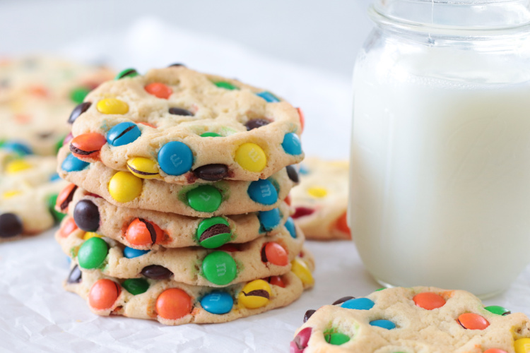 stack of M&M cookies and a glass of milk