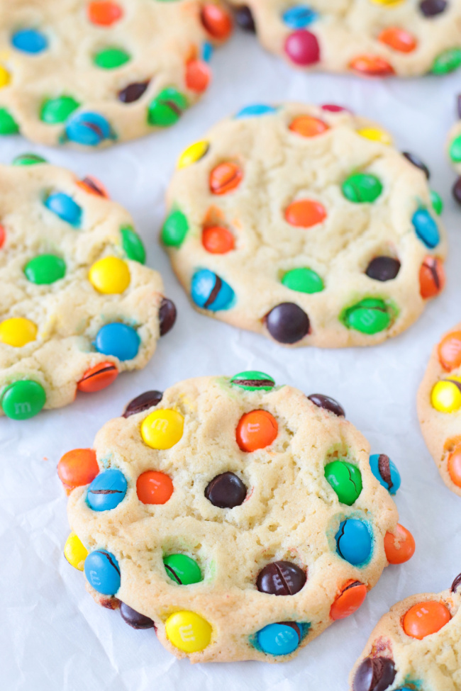 bakery style M&M cookies on parchment paper