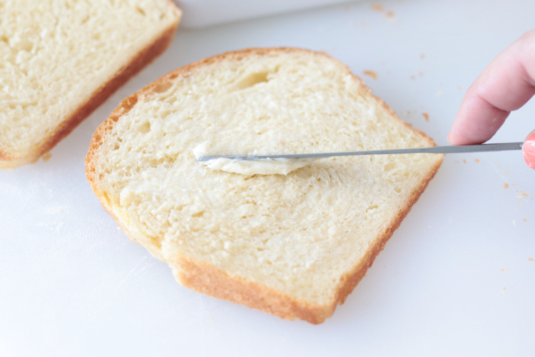 slice of bread being buttered