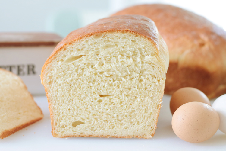 loaf of egg bread on cutting board