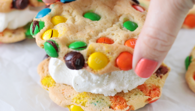 hand placing second cookie on ice cream sandwich