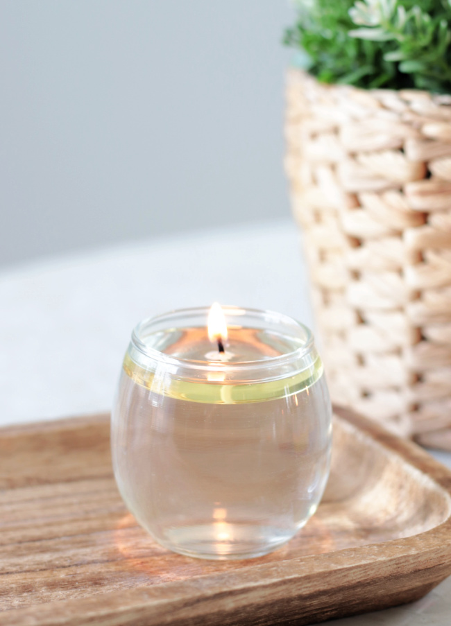 plain water candle on wood platter