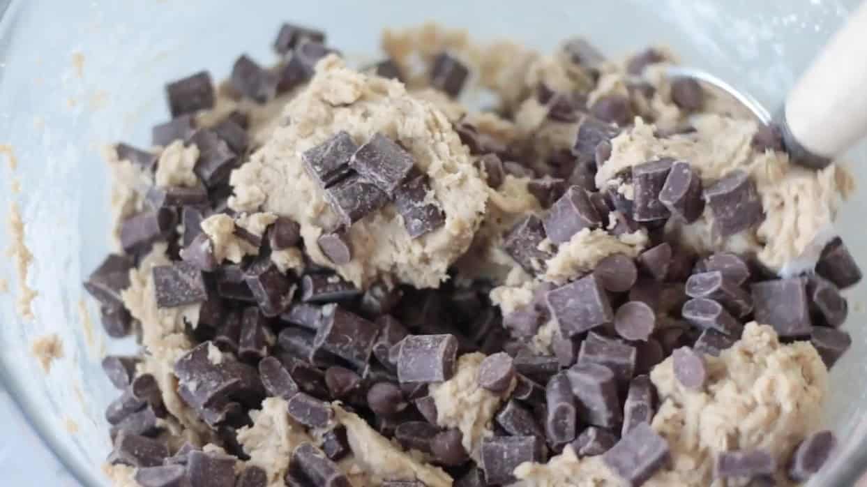 Bowl of cookie dough with chocolate chips and chocolate chunks.