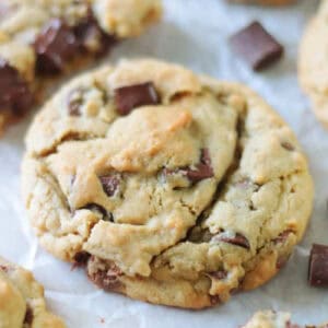 Chocolate chunk cookies on parchment paper.