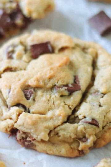 Chocolate chunk cookies on parchment paper.