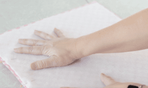 hand pressing on fabric