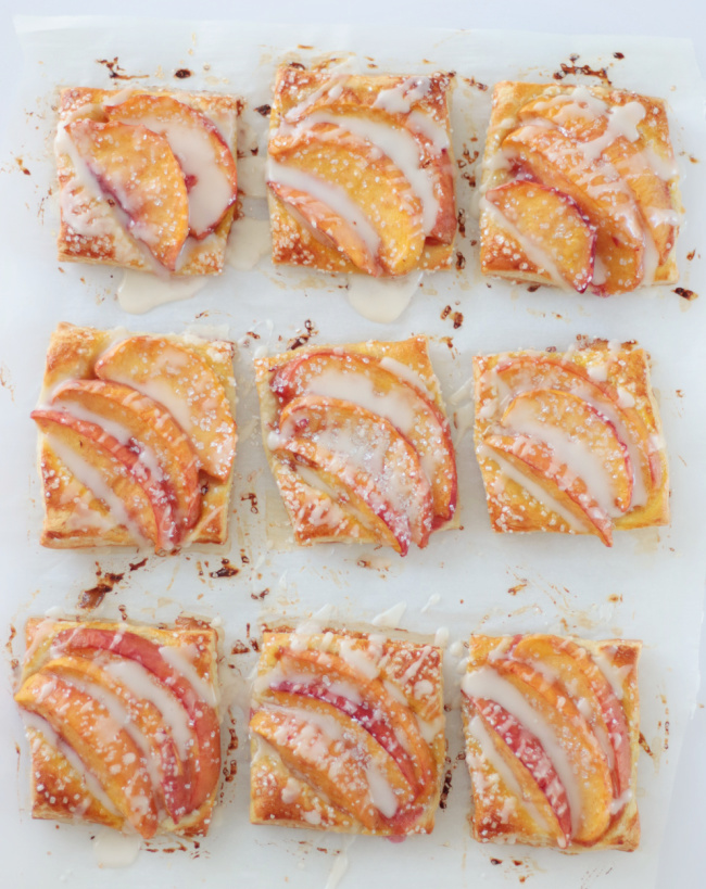 8 mini peach tarts on parchment paper