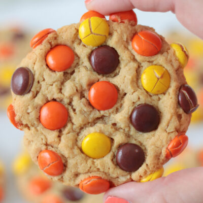 hand holding reese's pieces peanut butter cookie