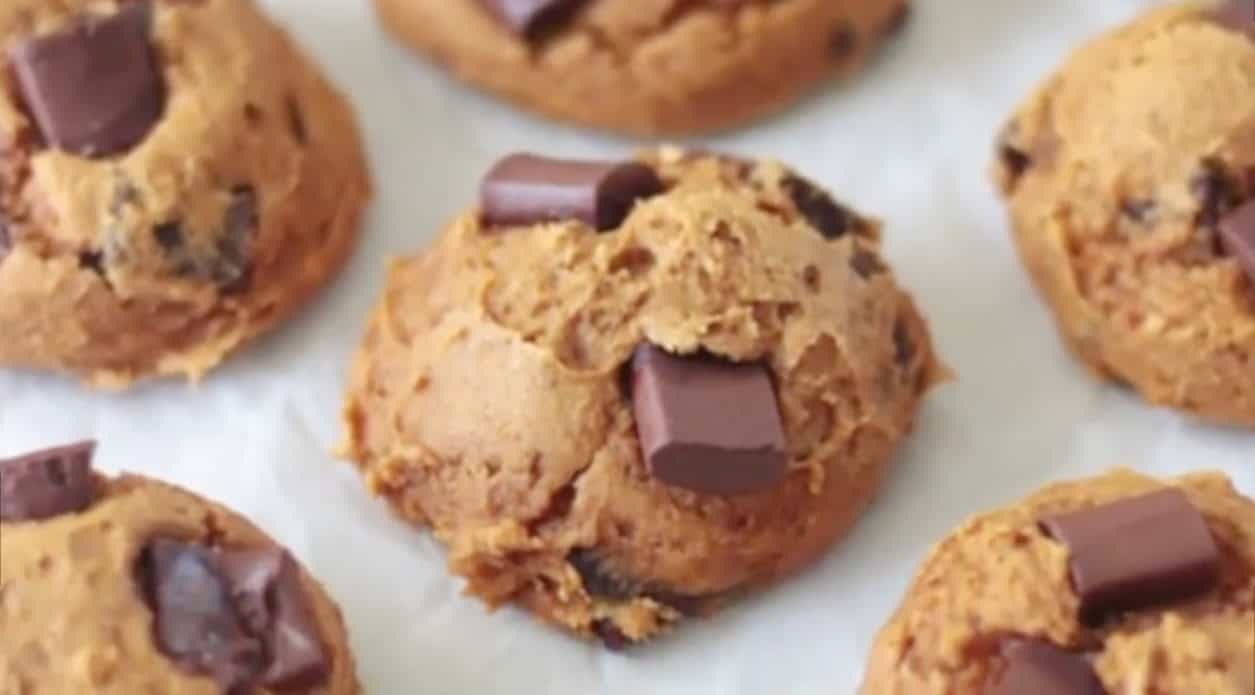 Baked 3-ingredient pumpkin cookies on parchment paper.