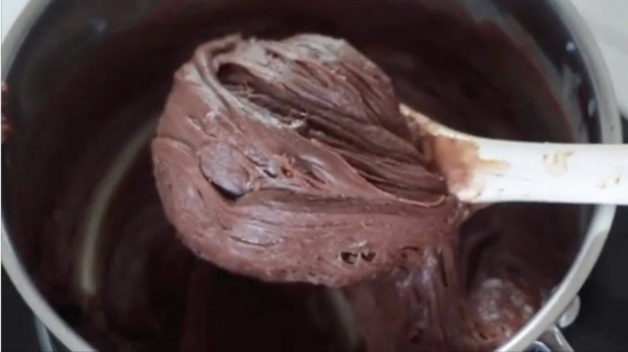 Chocolate fudge mixture in saucepan.
