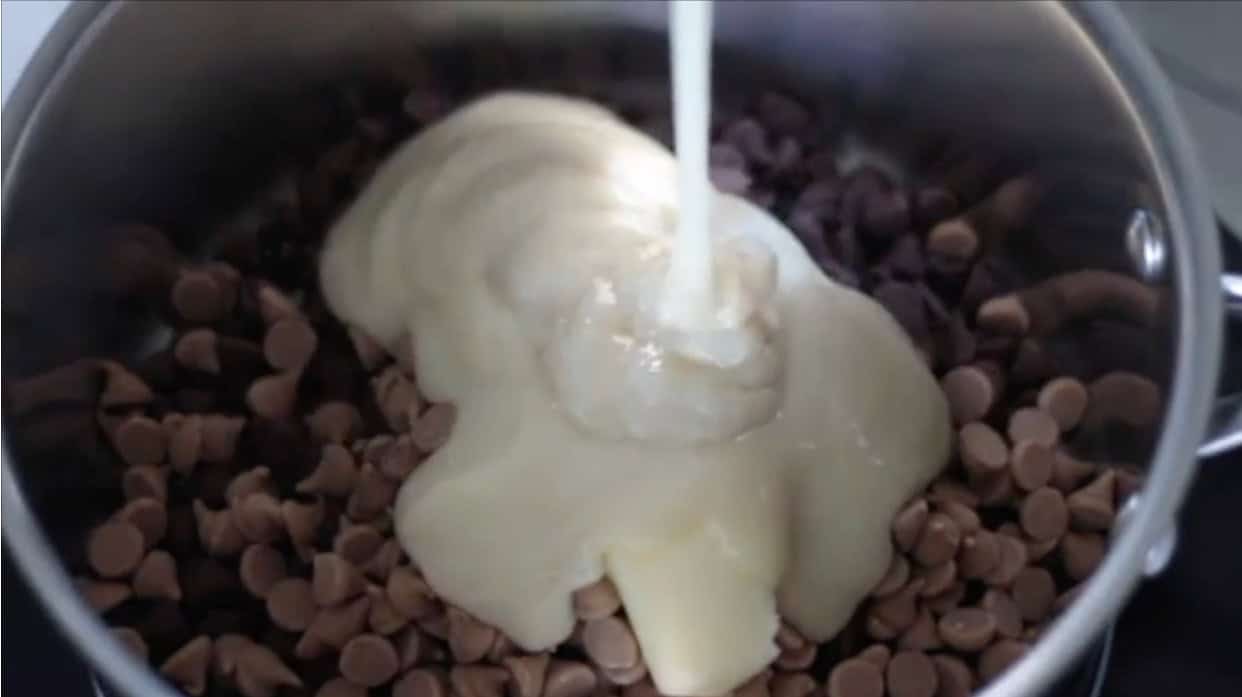 Saucepan of sweetened condensed milk, chocolate chips and peanut butter chips.