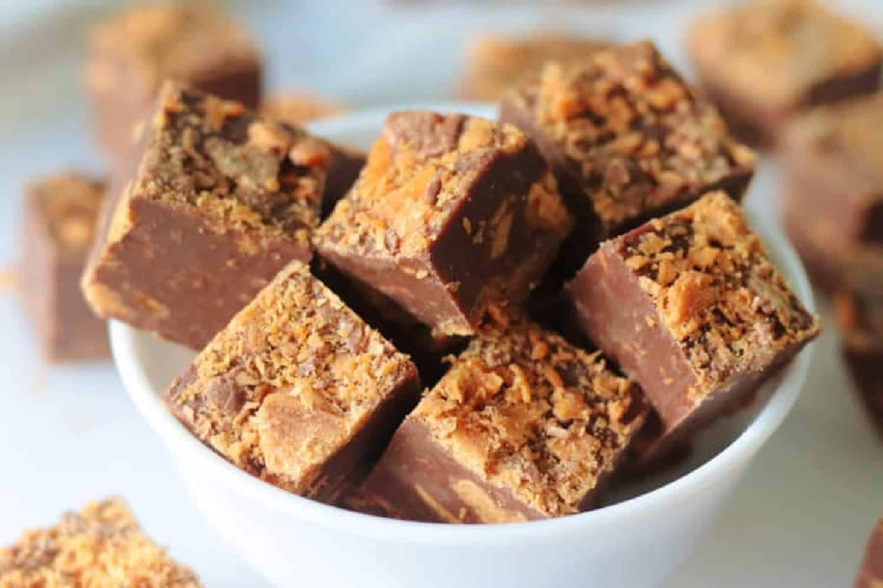 Bowl of squares of butterfinger fudge.