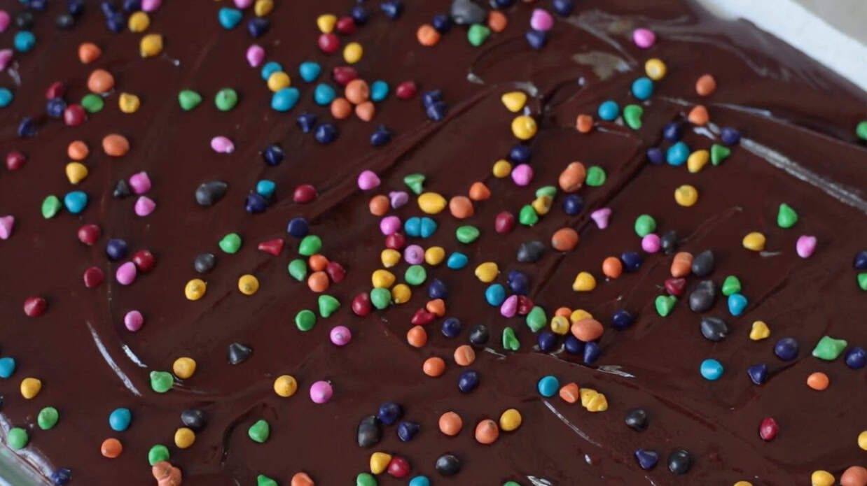 Cosmic brownies coated in ganache and rainbow sprinkles.